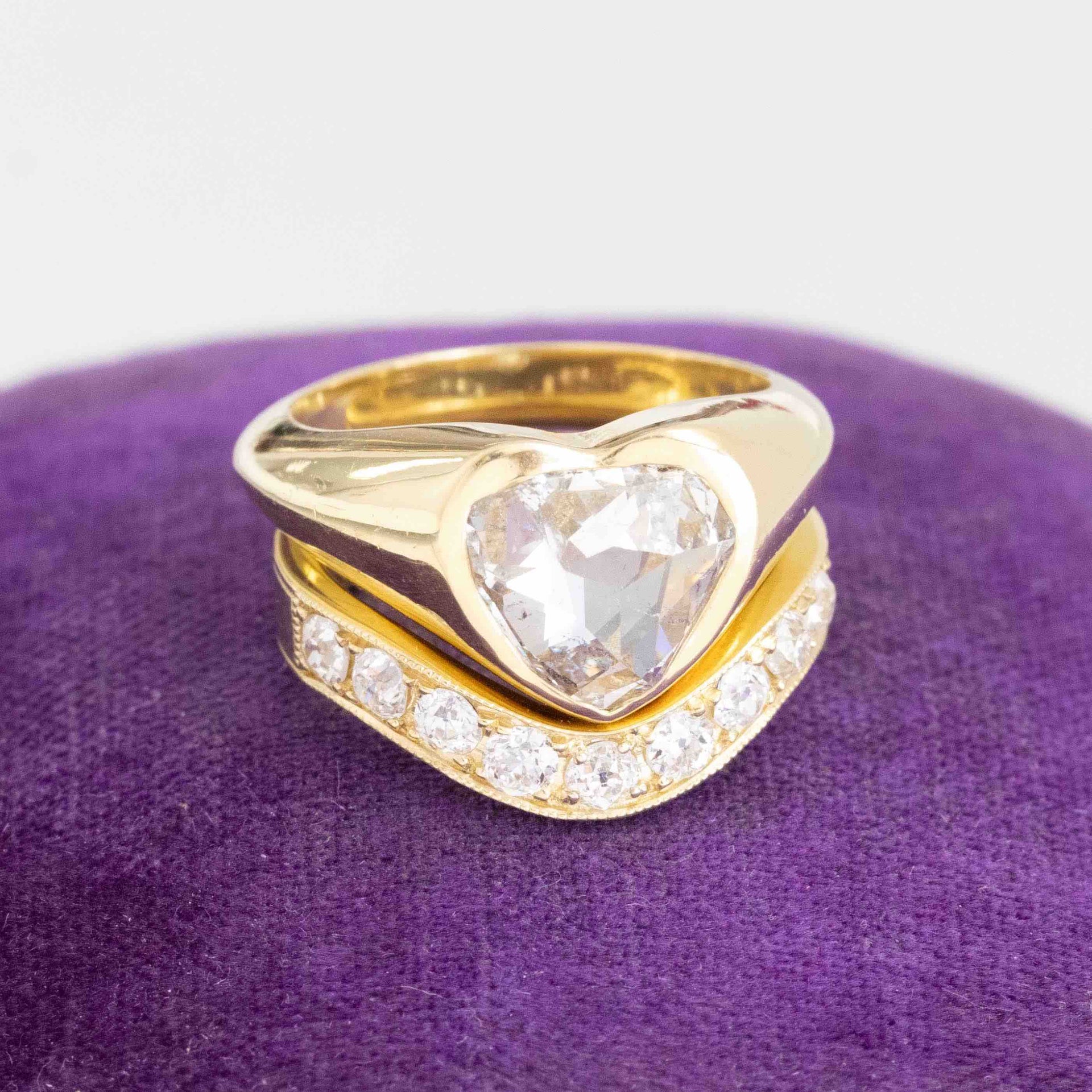 Chunky bezel-set pear cut diamond solitaire paired with an Old European cut diamond curved wedding band, styled for a seamless contour fit.