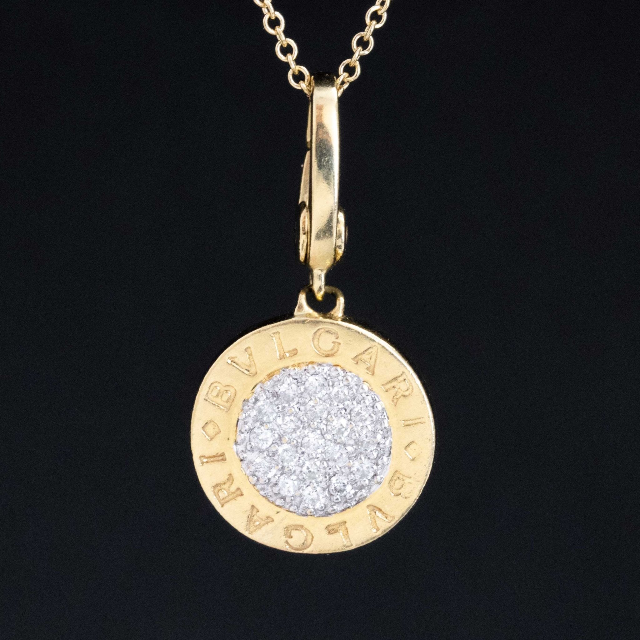 Authentic vintage Bvlgari round pendant in 18k yellow gold with pavé-set white diamonds and engraved BVLGARI logo, collectible Italian designer jewelry for luxury vintage and antique jewelry lovers from Jewels by Grace.