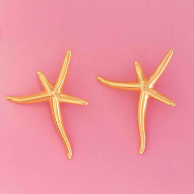 Large starfish earrings by Elsa Peretti for Tiffany & Co. in 18kt yellow gold on pink background
