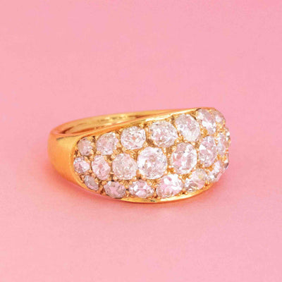 French antique cluster dome ring with old mine cut diamonds in 18kt yellow gold on pink background