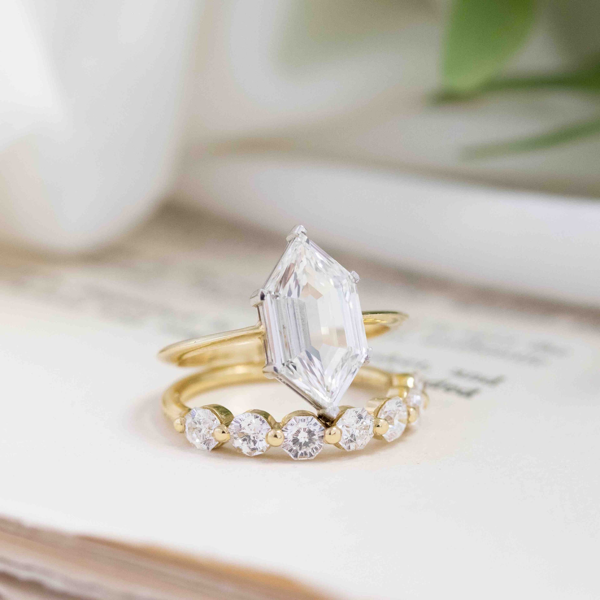 Hexagonal step cut diamond solitaire paired with a matching half-hoop radiant cut diamond band