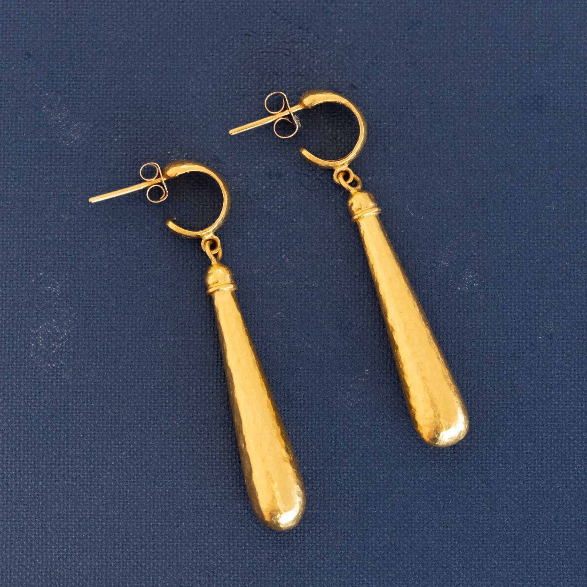 Close-up of Gurhan elongated drop earrings with lustrous finish