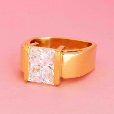Retro princess cut diamond solitaire ring in 18kt yellow gold with 4.05ct GIA diamond on pink background