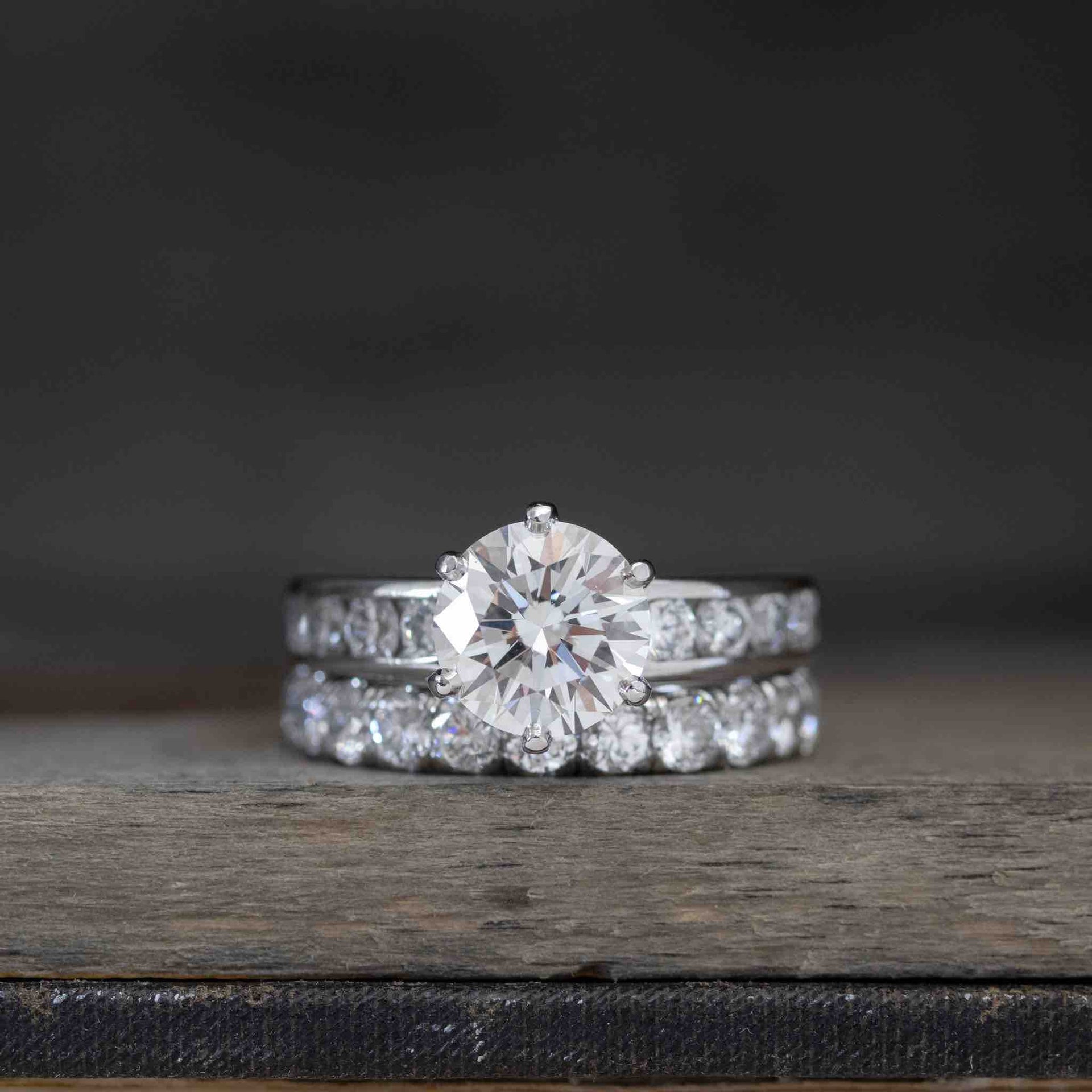 2.12ct Tiffany & Co. solitaire engagement ring paired with a 3.50ctw prong-set diamond eternity band in platinum