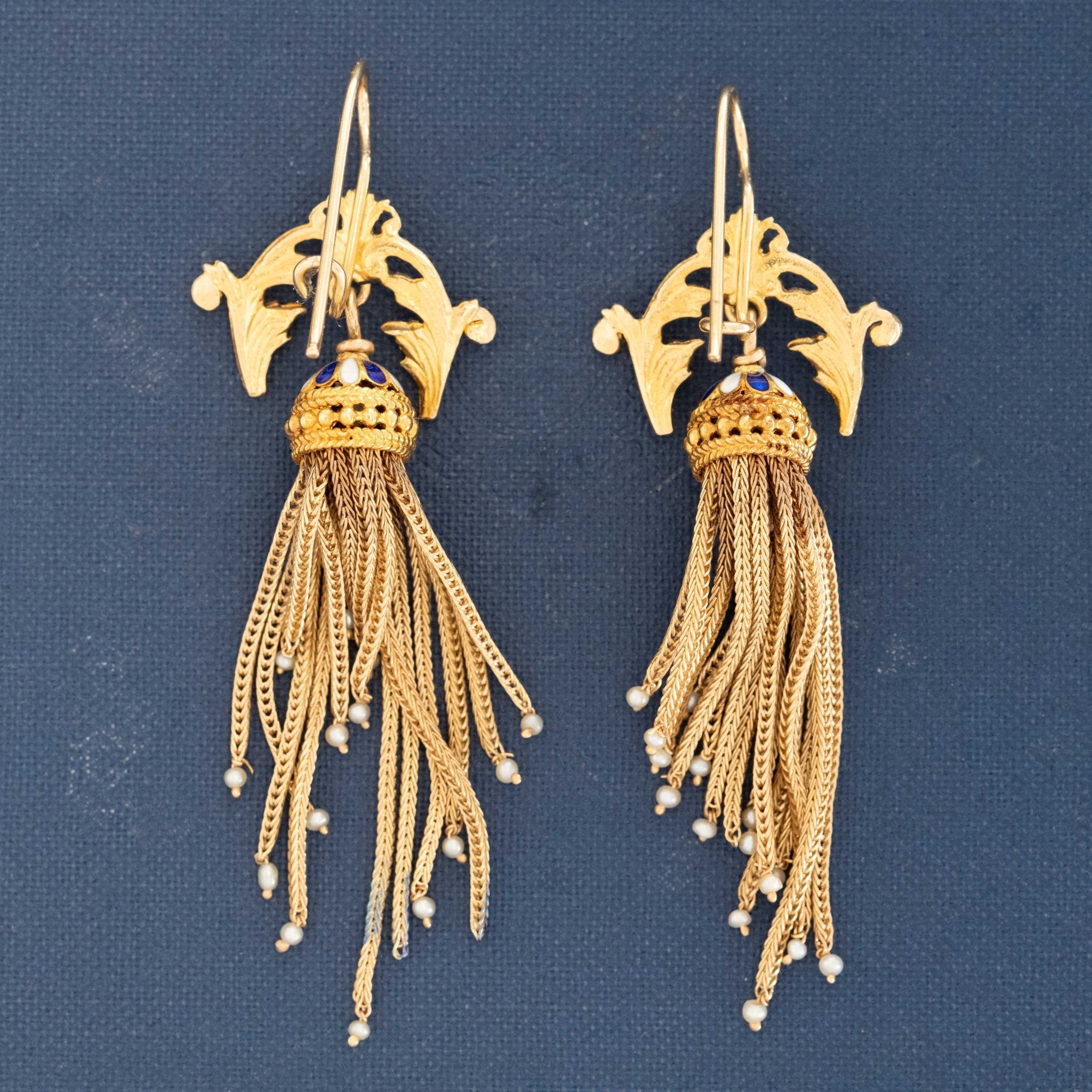 Close-up of ornate 15k gold Victorian earrings with enamel dome and seed pearl tassels