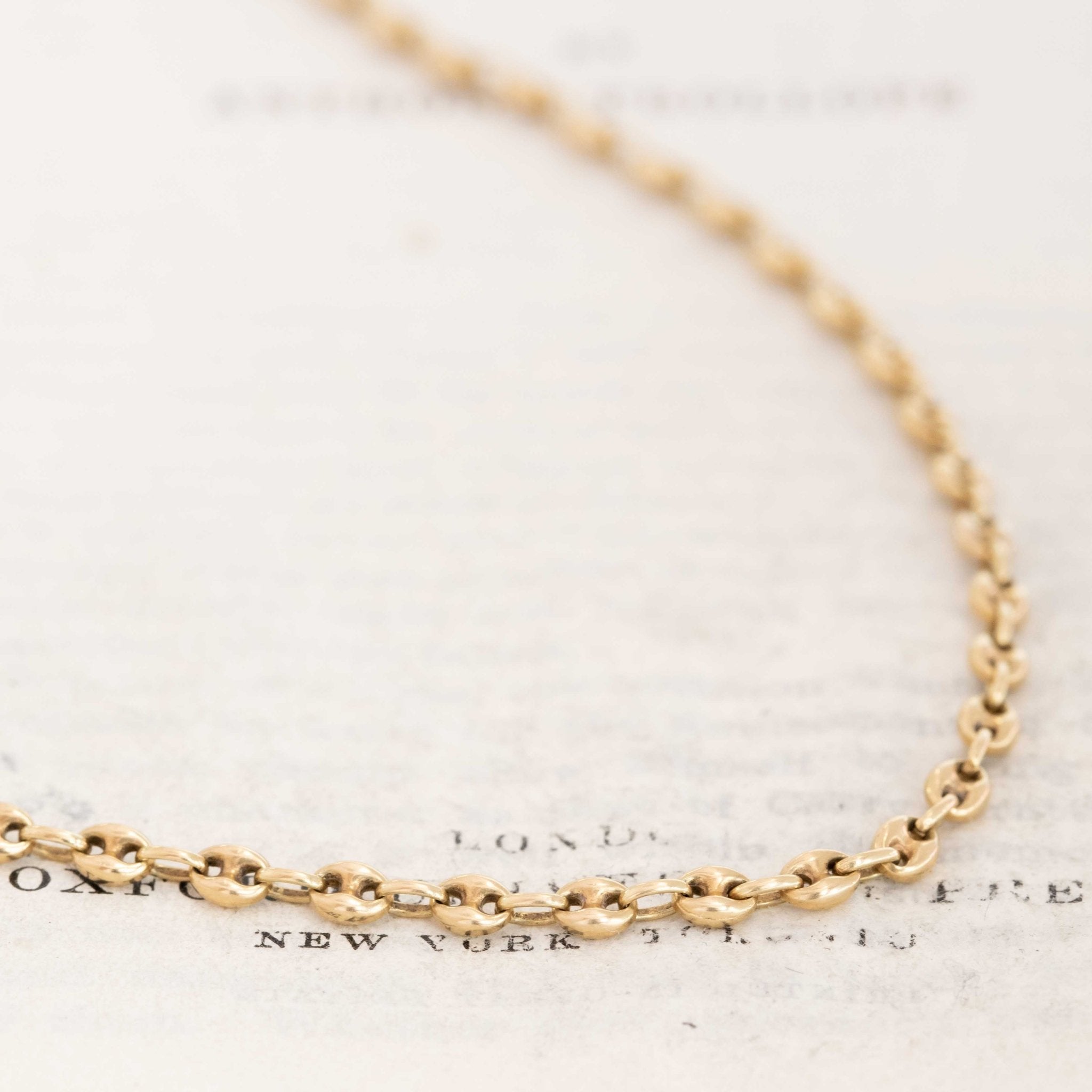 Vintage 14k yellow gold mariner link chain necklace on white background