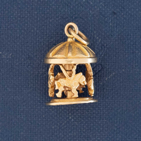 14k gold articulating carousel pendant charm with moving design.