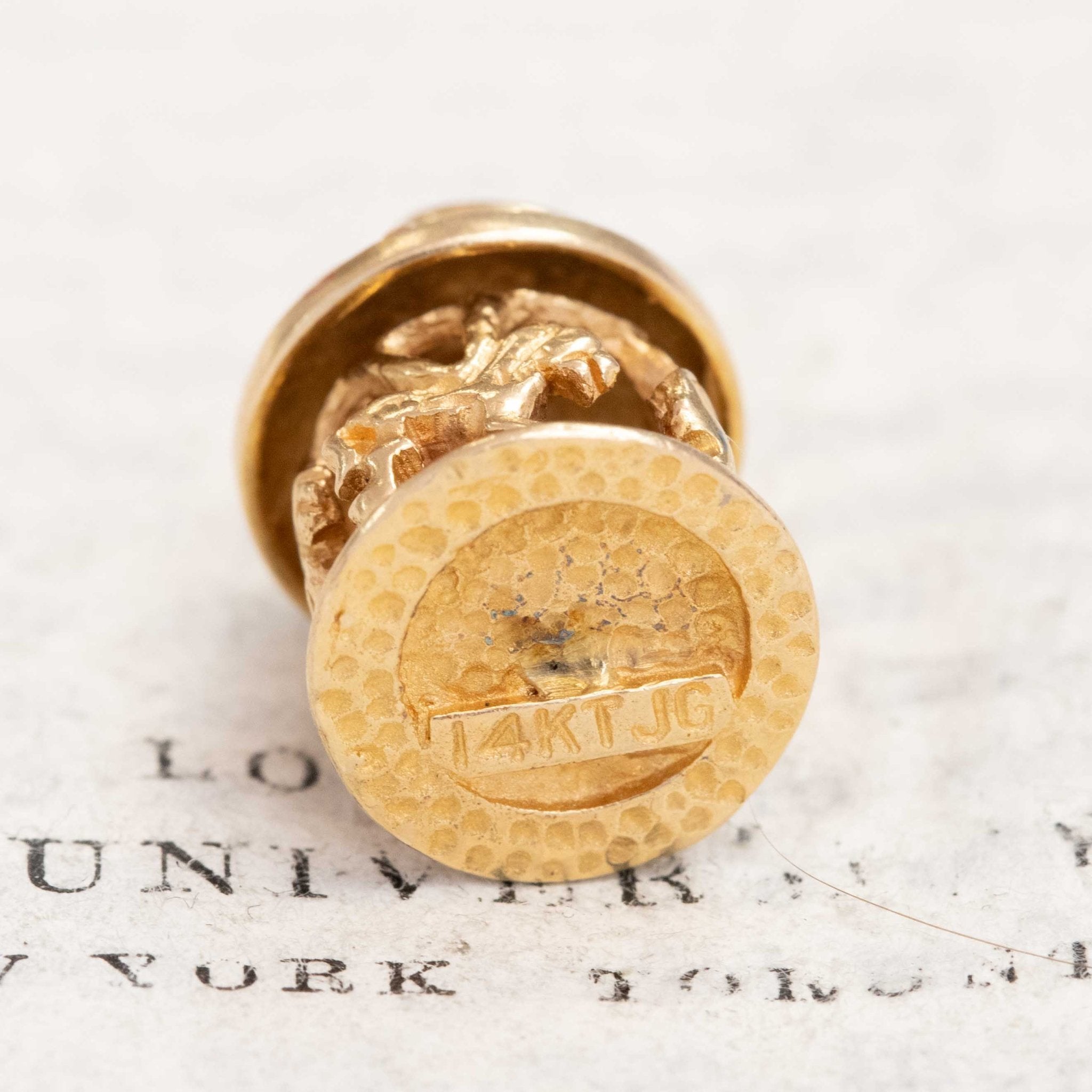 Whimsical vintage carousel charm in yellow gold, miniature horse details visible.