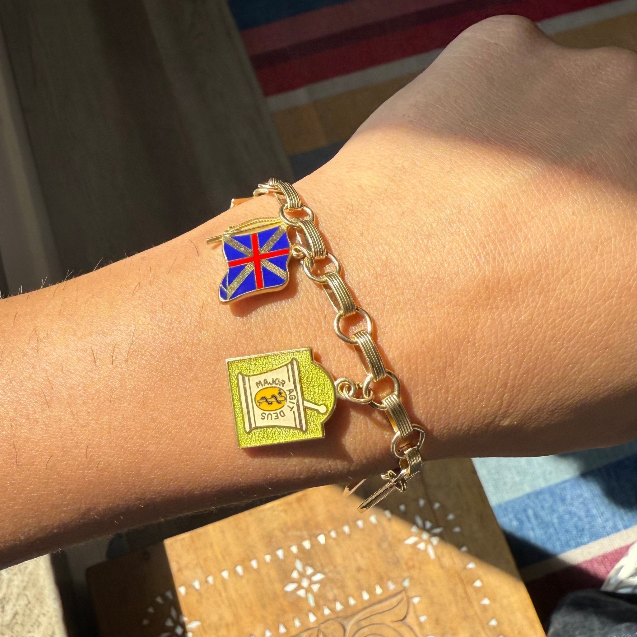Antique charm bracelet, enamel depictions of colonial scenes on wrist