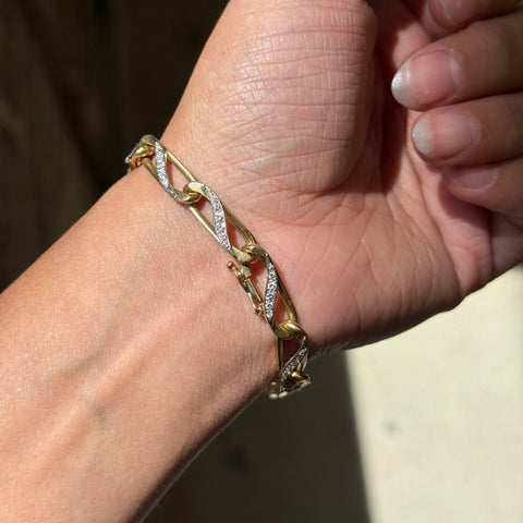 Close-up of vintage Bvlgari pavé diamond twist links shown on wrist