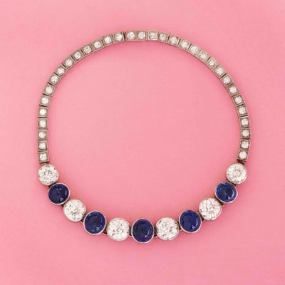 Vintage flexible bracelet with Pailin sapphire cabochons and old European cut diamonds in platinum on pink background