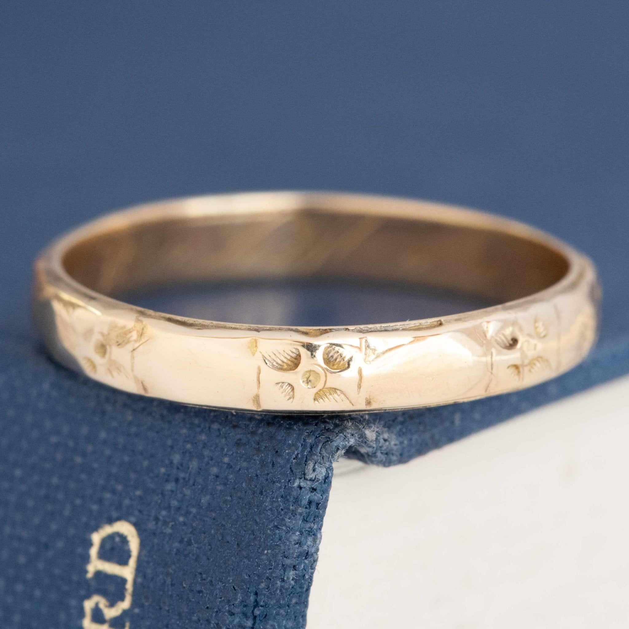 Antique 14kt yellow gold etched wedding band with rich patina and timeless design.