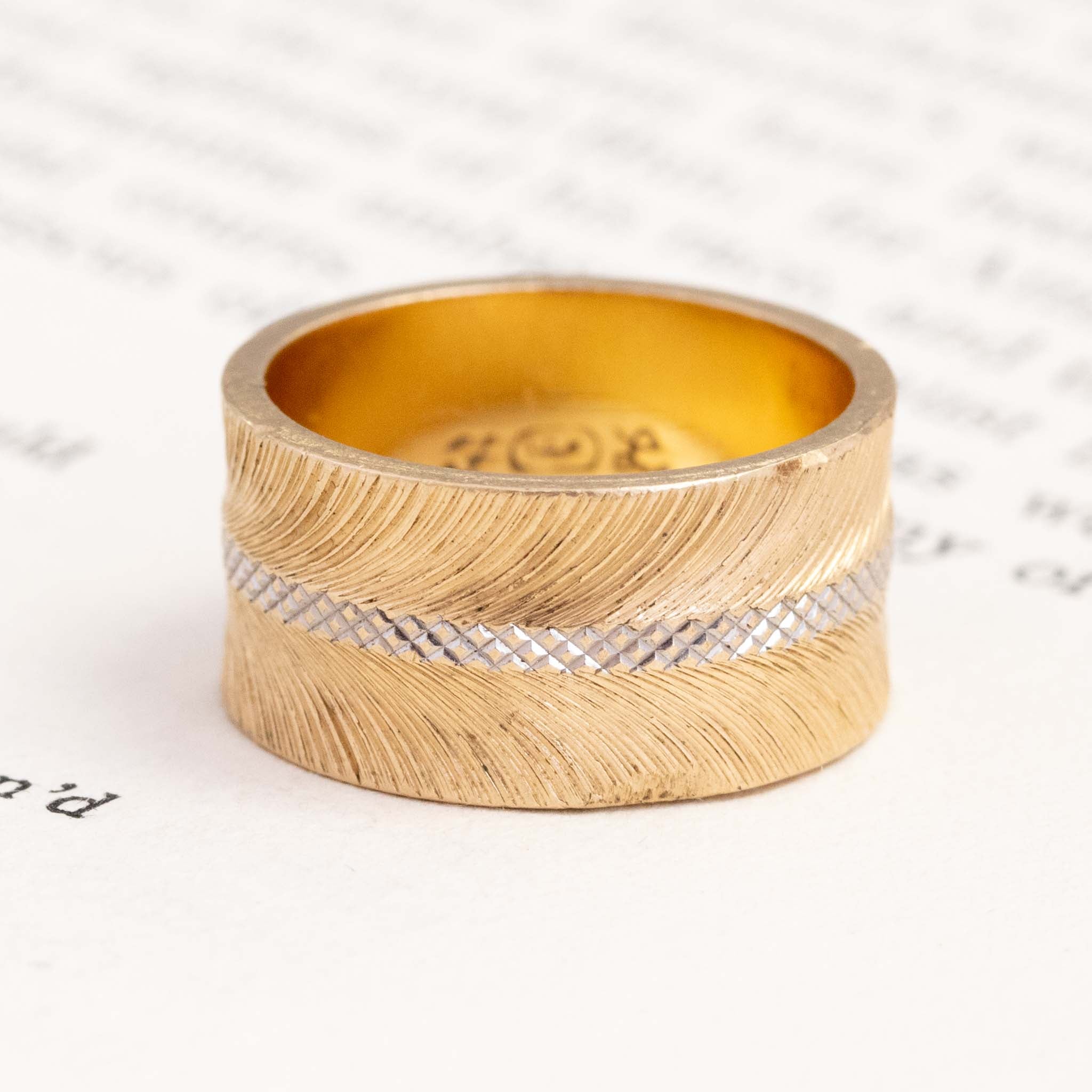 14kt yellow gold feather and cross hatch wedding band with a rhodium plated center cross hatch