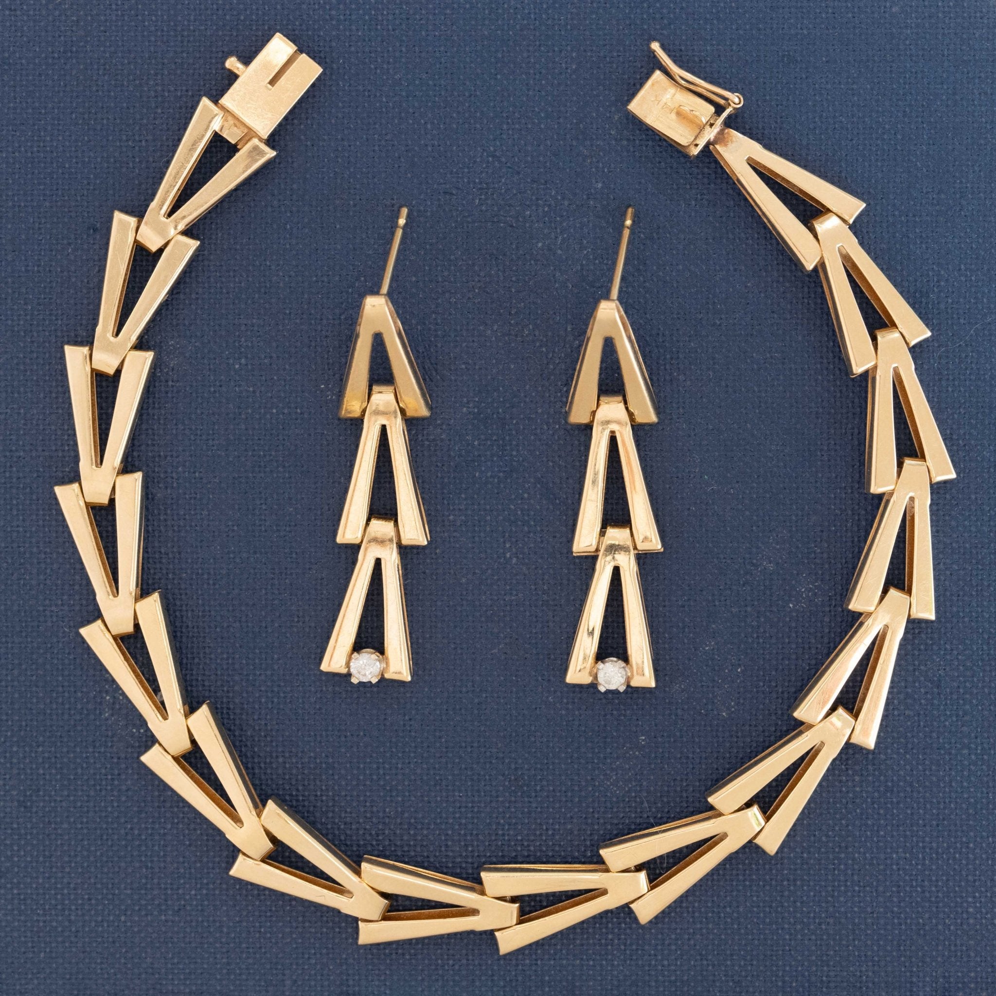 Yellow gold V-link drop earrings styled as part of a fine jewelry set with diamonds