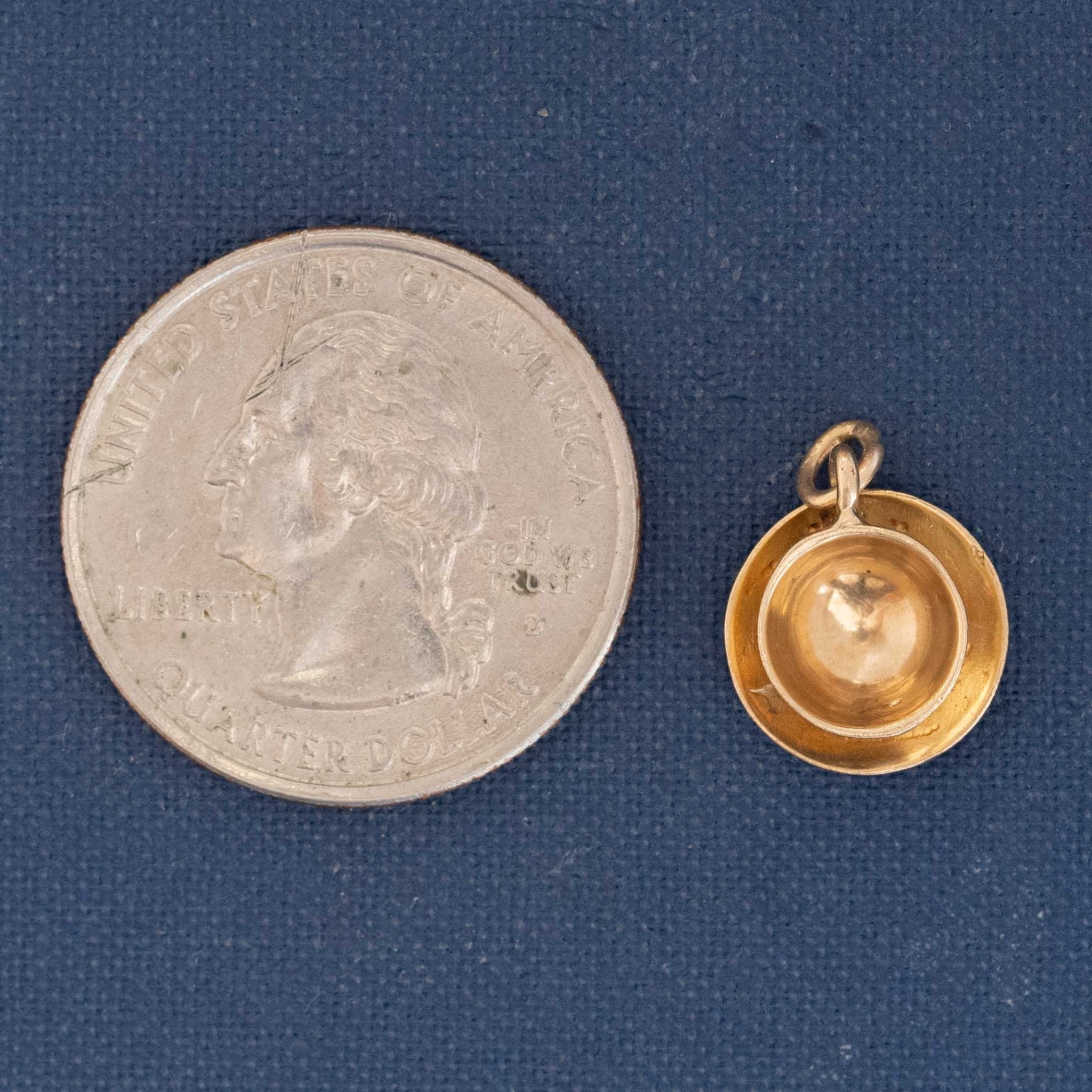 Vintage figural gold cup charm with saucer, collectible novelty pendant.