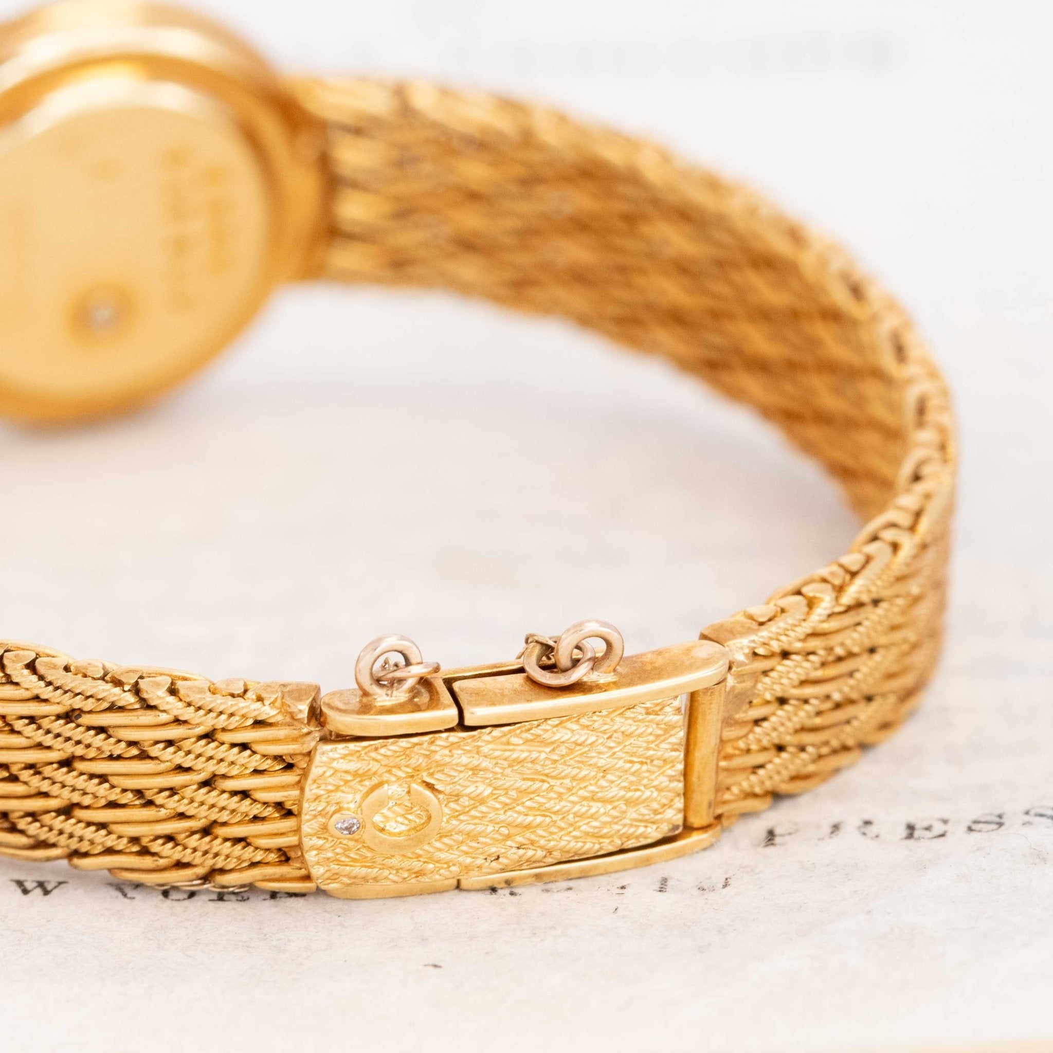 Gold Chopard Happy Diamonds timepiece on wrist