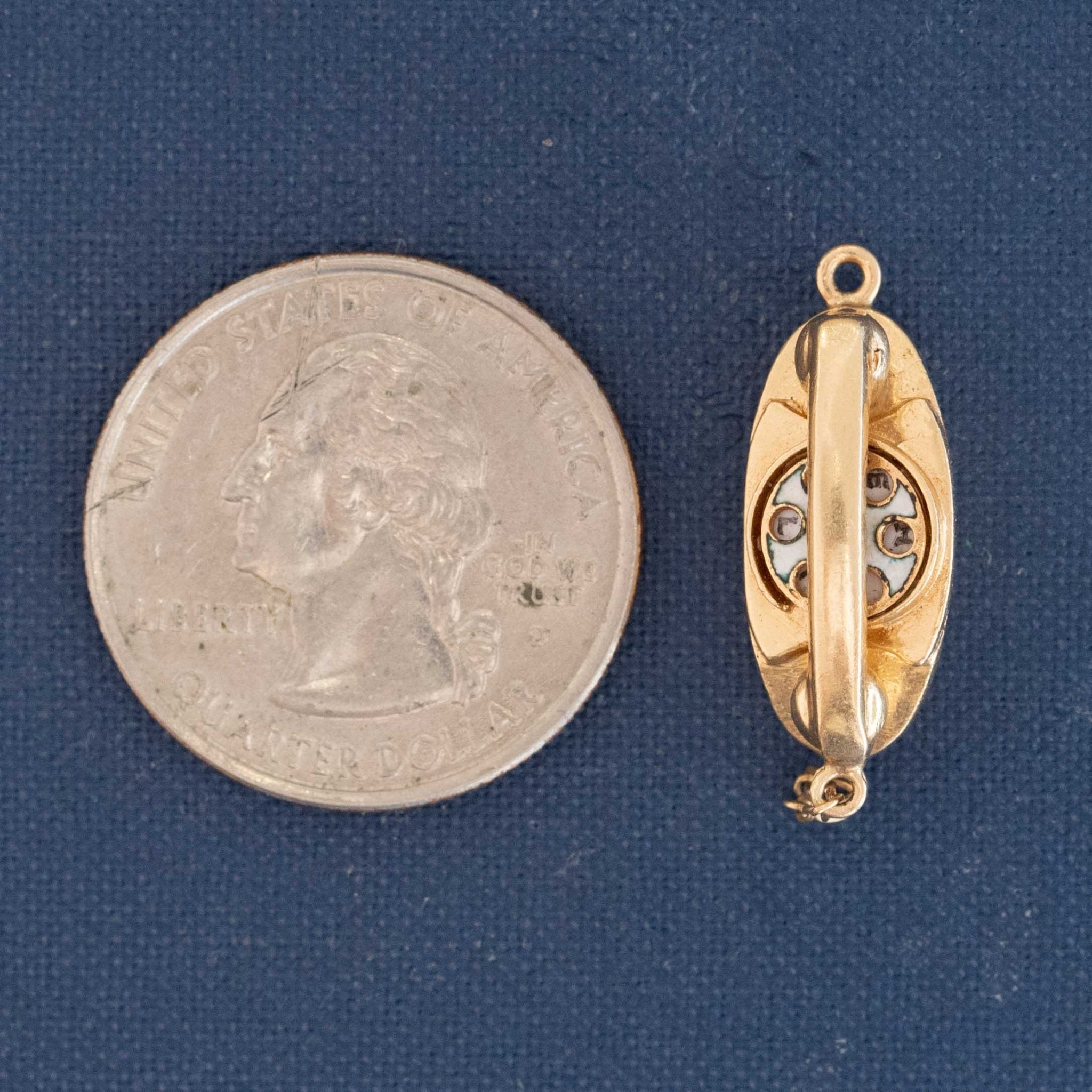 Close-up of vintage 14kt gold telephone charm with engraved dial