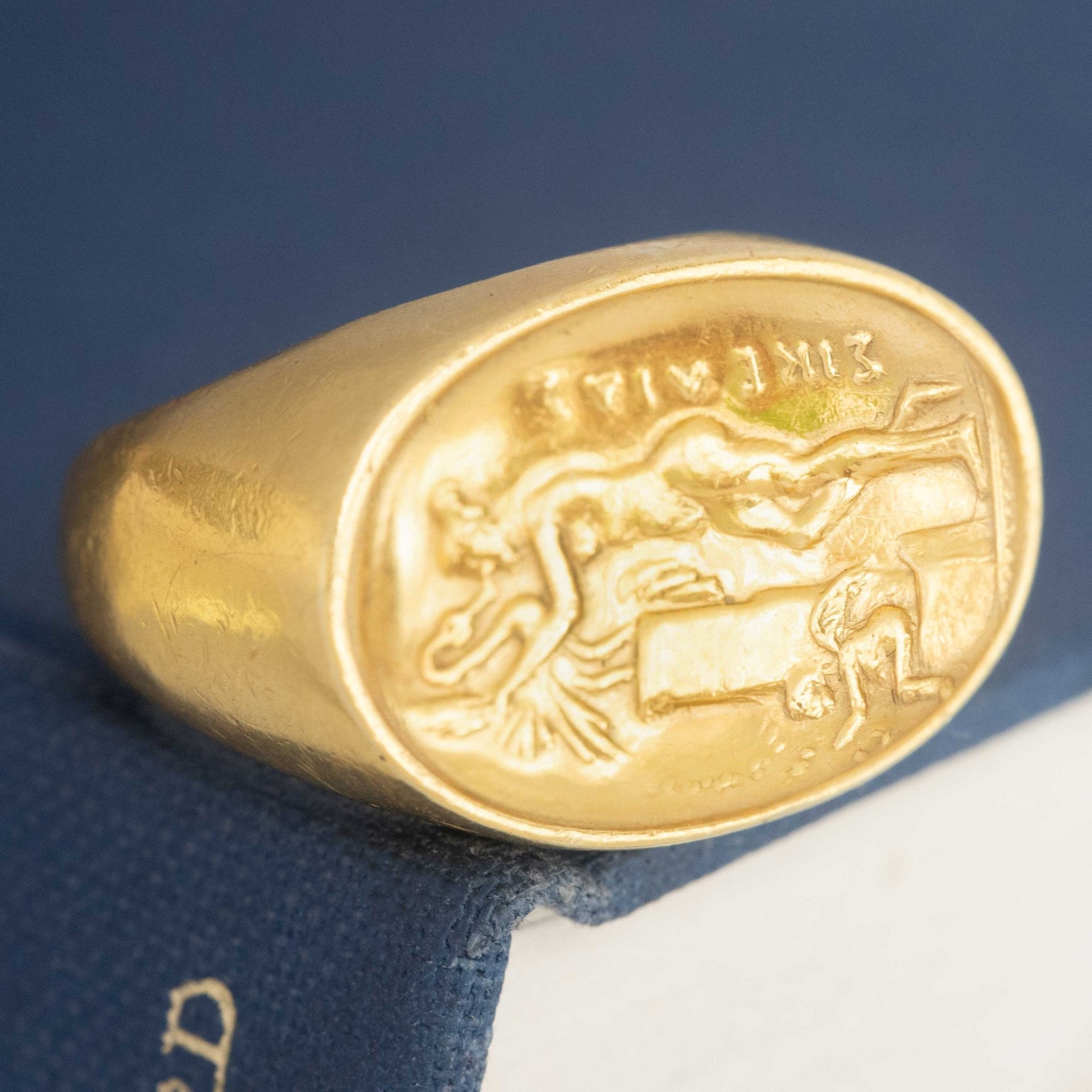 A vintage high karat signet ring  by designer Zolotas depicting "Leda and the swan."  One of a kind and a rare jewel.