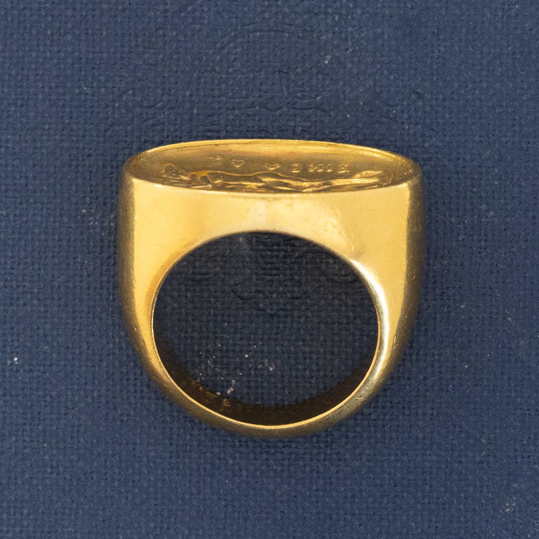 A vintage high karat signet ring  by designer Zolotas depicting "Leda and the swan."  One of a kind and a rare jewel.