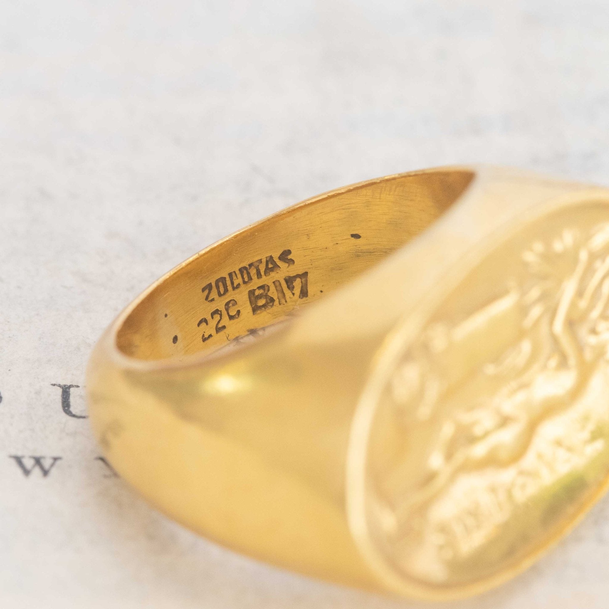 A vintage high karat signet ring  by designer Zolotas depicting "Leda and the swan."  One of a kind and a rare jewel.