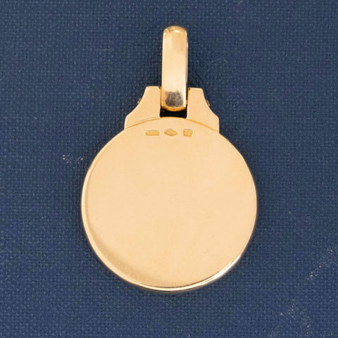 Vintage Bvlgari Libra zodiac pendant crafted in Italy from 18‑karat yellow gold with a contrasting stainless‑steel or white‑gold outer ring. The circular disc is engraved with the BVLGARI logo and features the Libra scales motif at the centre, and it bears hallmarks such as ‘Made in Italy’ and ‘750’. Measuring roughly 1.23 inches in diameter and weighing about 13 grams, the pendant is numbered on the reverse and hangs from a substantial bail for easy wear as a charm or necklace.