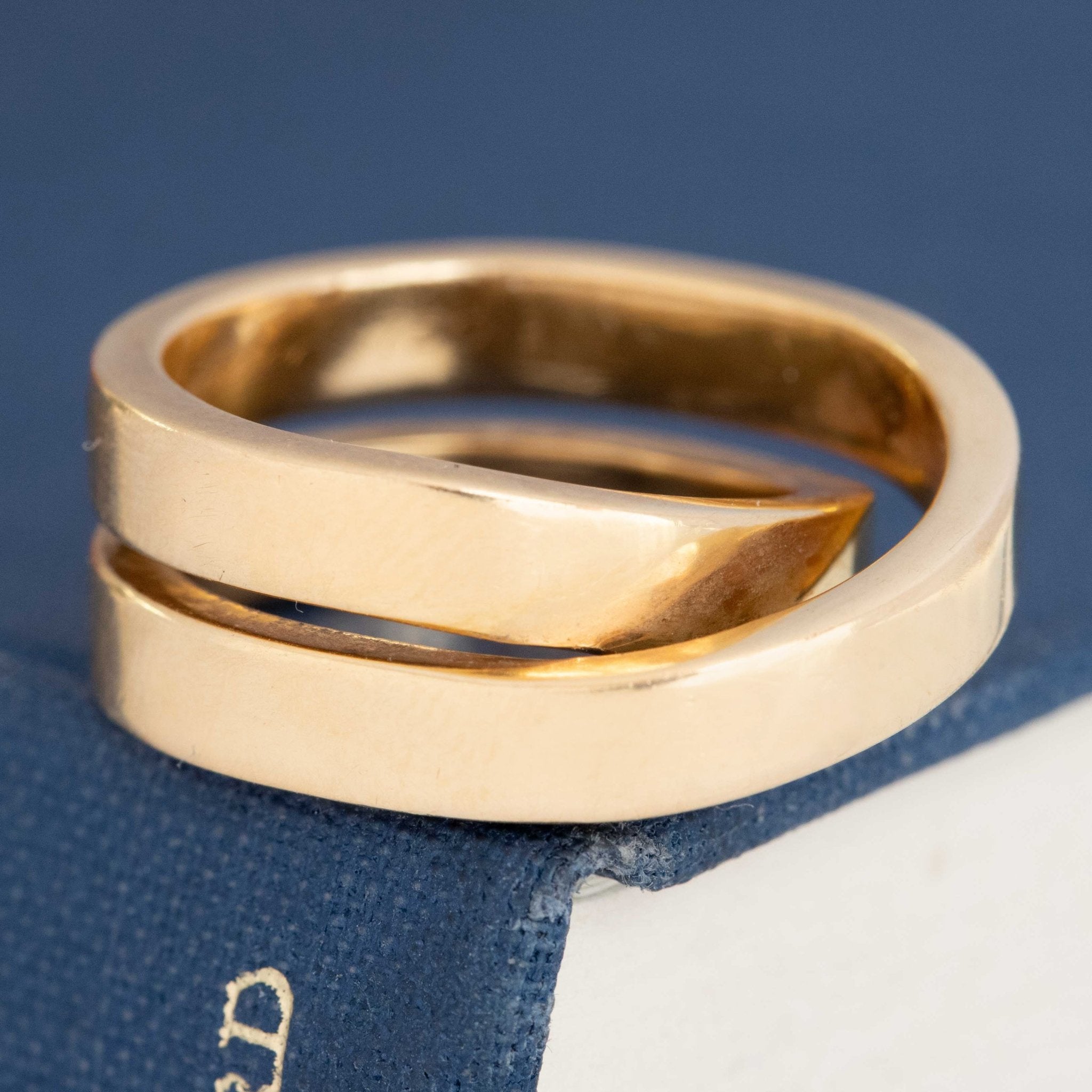 Vintage Cartier gold crossover ring, bold and refined with architectural silhouette.
