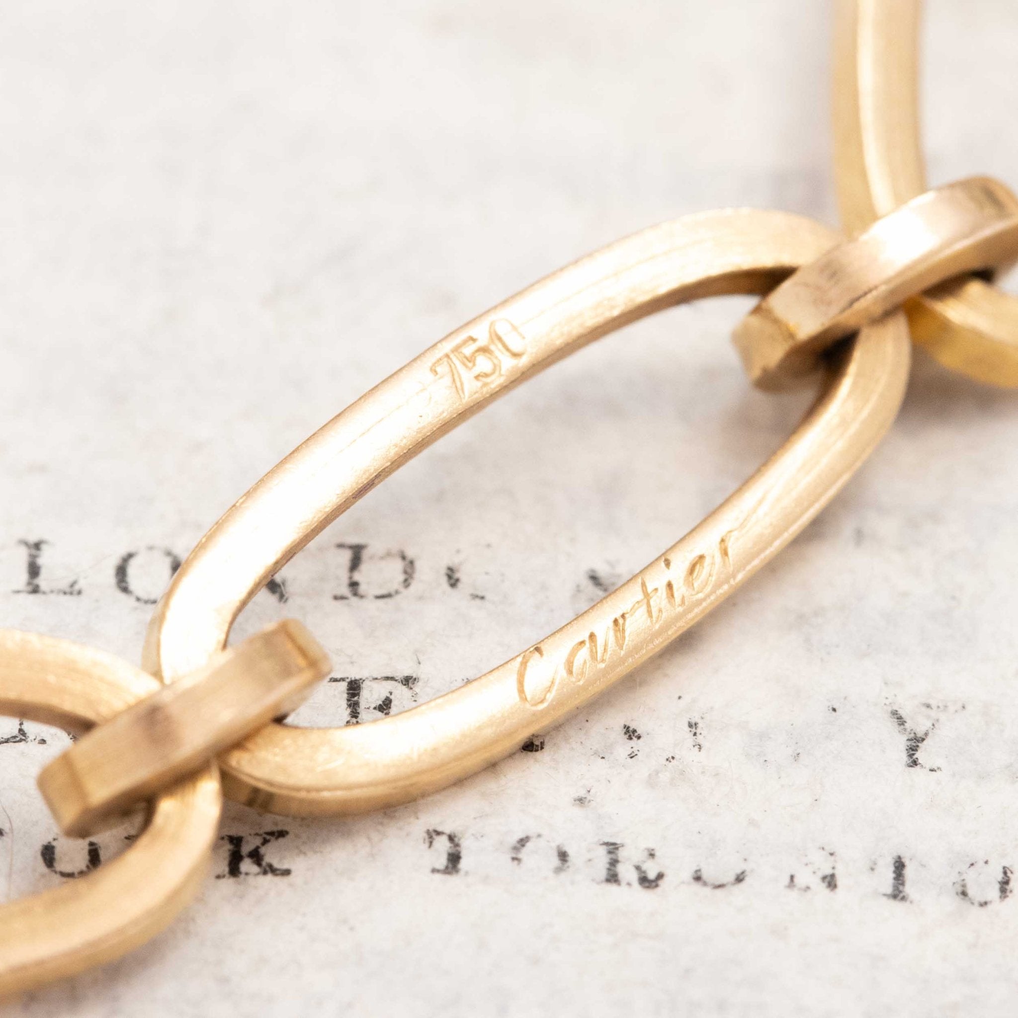 Detail shot: Cartier mark on link clasp, oval links design, vintage chain