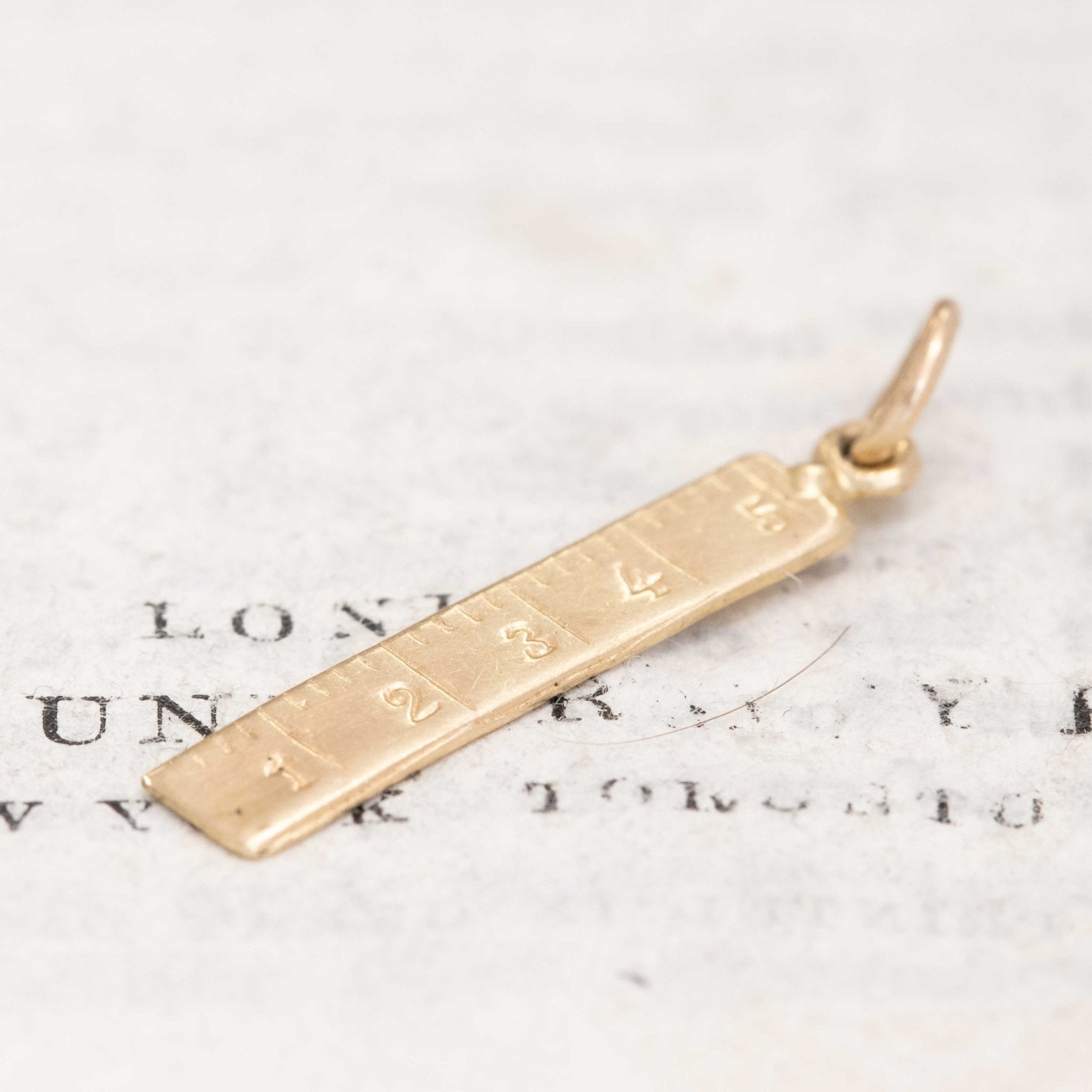 collectible gold ruler charm pendant
