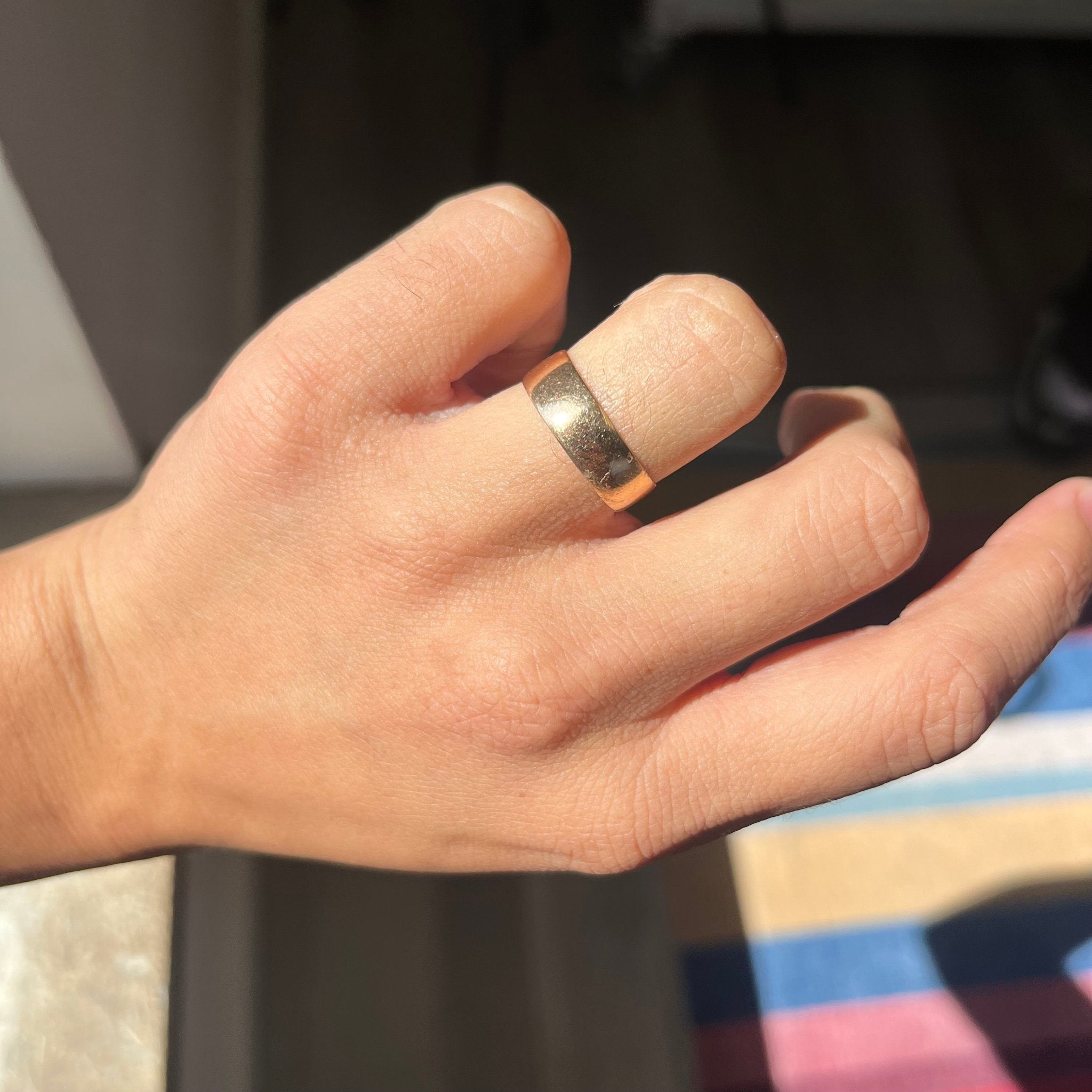 Antique 18kt gold wedding ring with rich high-karat luster.