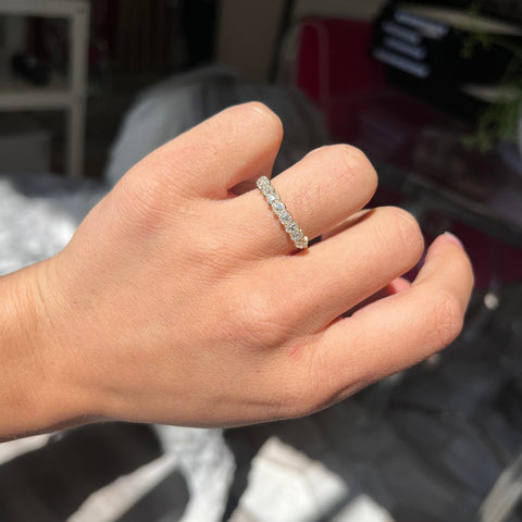 Elegant 1.03ctw Old Mine Cut Diamond 9-Stone Half-Hoop Band, romantic design with Old Mine Cut Diamonds, Earth-mined diamonds in yellow gold shown on ring finger