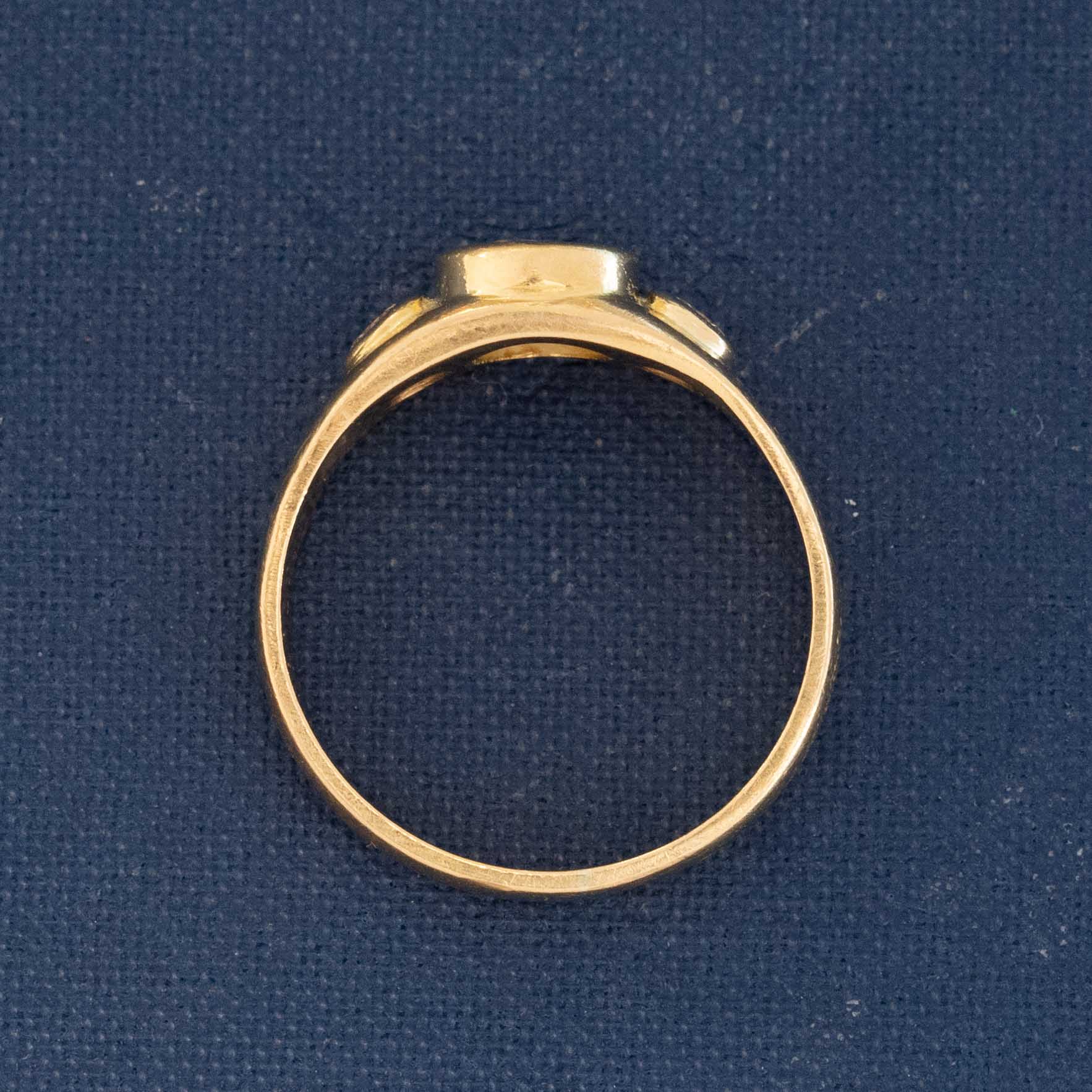 Side profile view of French 3-stone ring