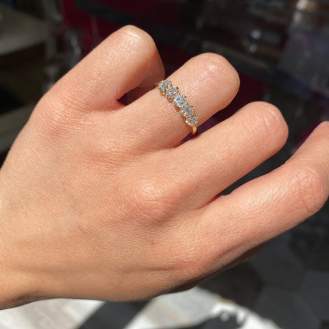 Elegant 1.05ctw Old Mine Cut Diamond 5-Stone Band, romantic design with Old Mine Cut Diamonds, Earth-mined diamonds in yellow gold shown on ring finger
