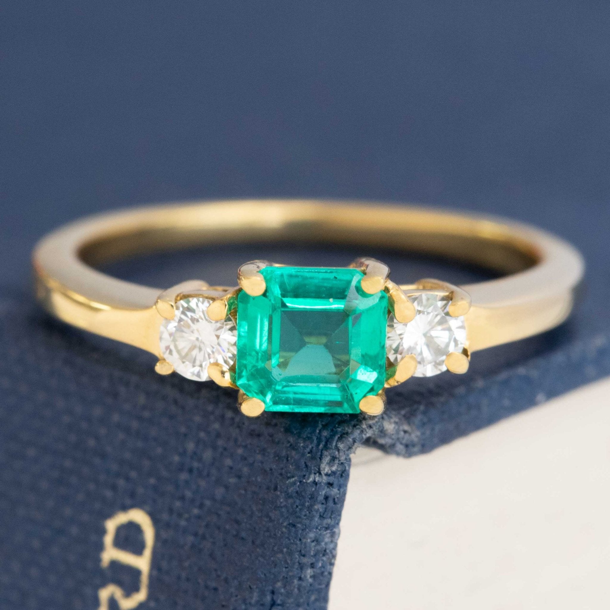 1.05ctw Step Cut Emerald & Diamond Trilogy Ring