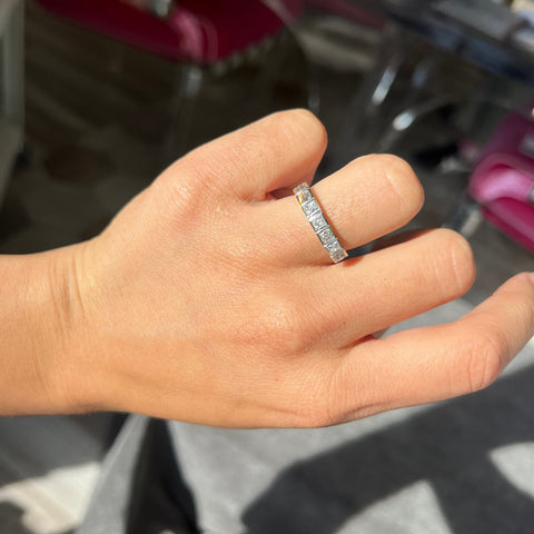 Elegant 1.06ctw French Cut Diamond 7-Stone Bezel Band, romantic design with French Cut Diamonds, Earth-mined diamonds in platinum shown on ring finger