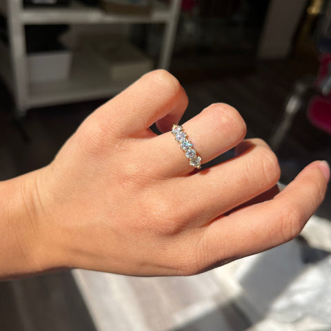 Elegant 1.10ctw Old European Cut Diamond 5-Stone Band, romantic design with Old European Cut Diamonds, Earth-mined diamonds in yellow gold shown on ring finger