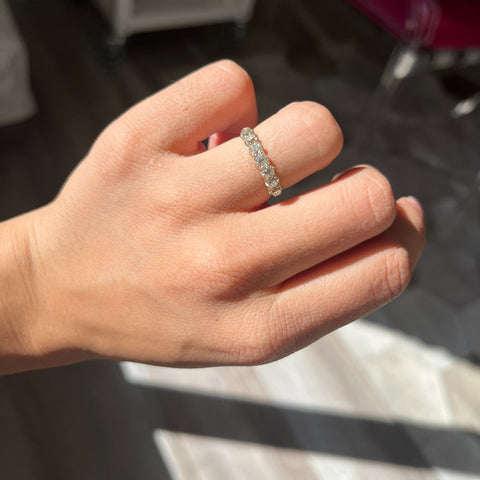 Elegant 1.11ctw Old Mine Cut Diamond 7-Stone Band, romantic design with Old Mine Cut Diamonds, Earth-mined diamonds in yellow gold shown on ring finger