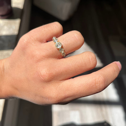Elegant 1.16ctw Old European Cut Diamond Graduated 5-Stone Band, romantic design with Old European Cut Diamonds, Earth-mined diamonds in yellow gold shown on ring finger