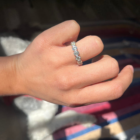 Elegant 1.27ctw Old European Cut Diamond Bezel Half-Hoop Band, romantic design with Old European Cut Diamonds, Earth-mined diamonds in platinum shown on ring finger