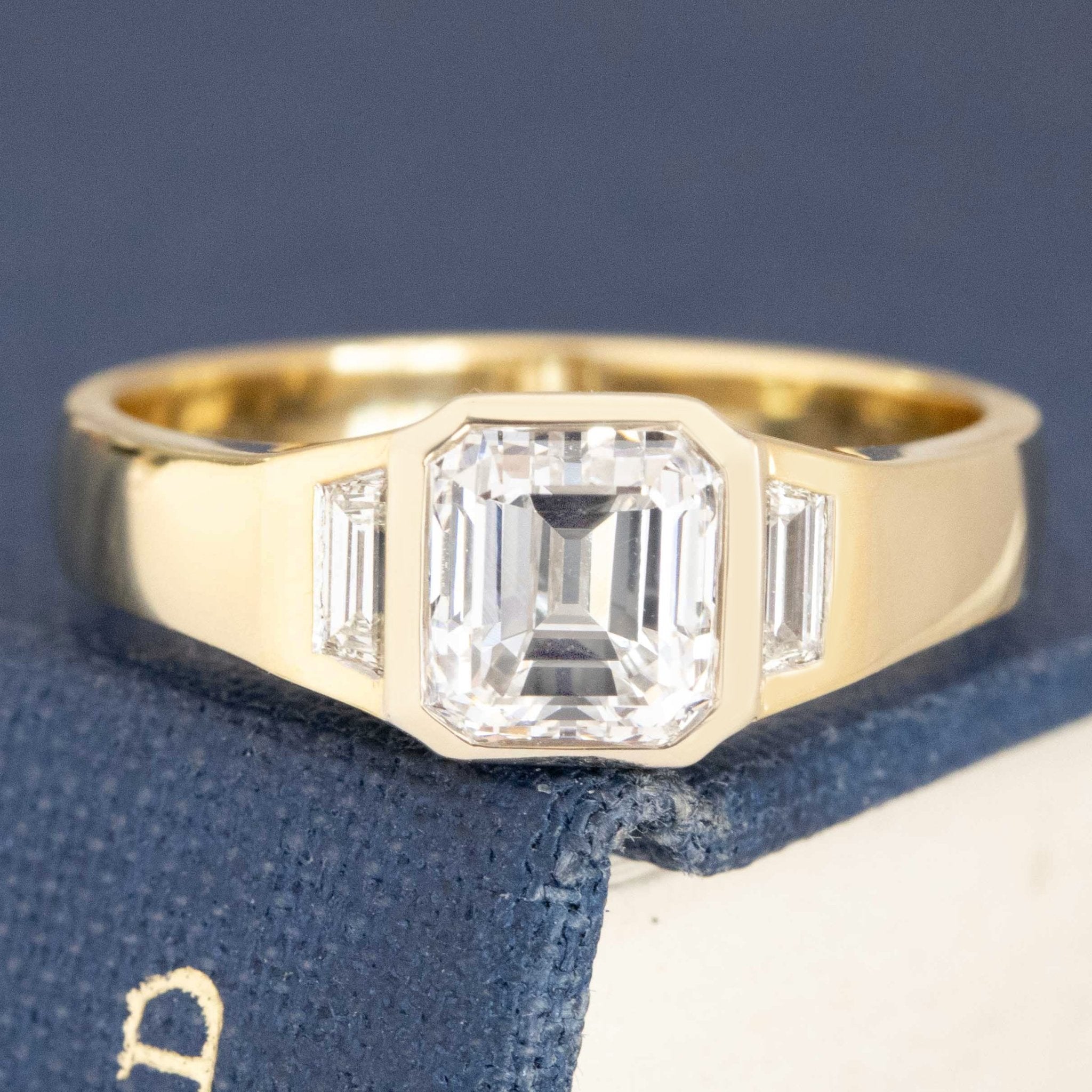1.31ctw Emerald Cut Diamond Bezel Trilogy Ring