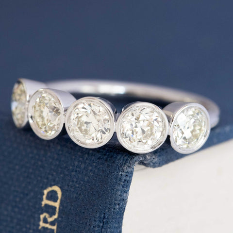 Close-up of antique diamonds bezel set, five stones band