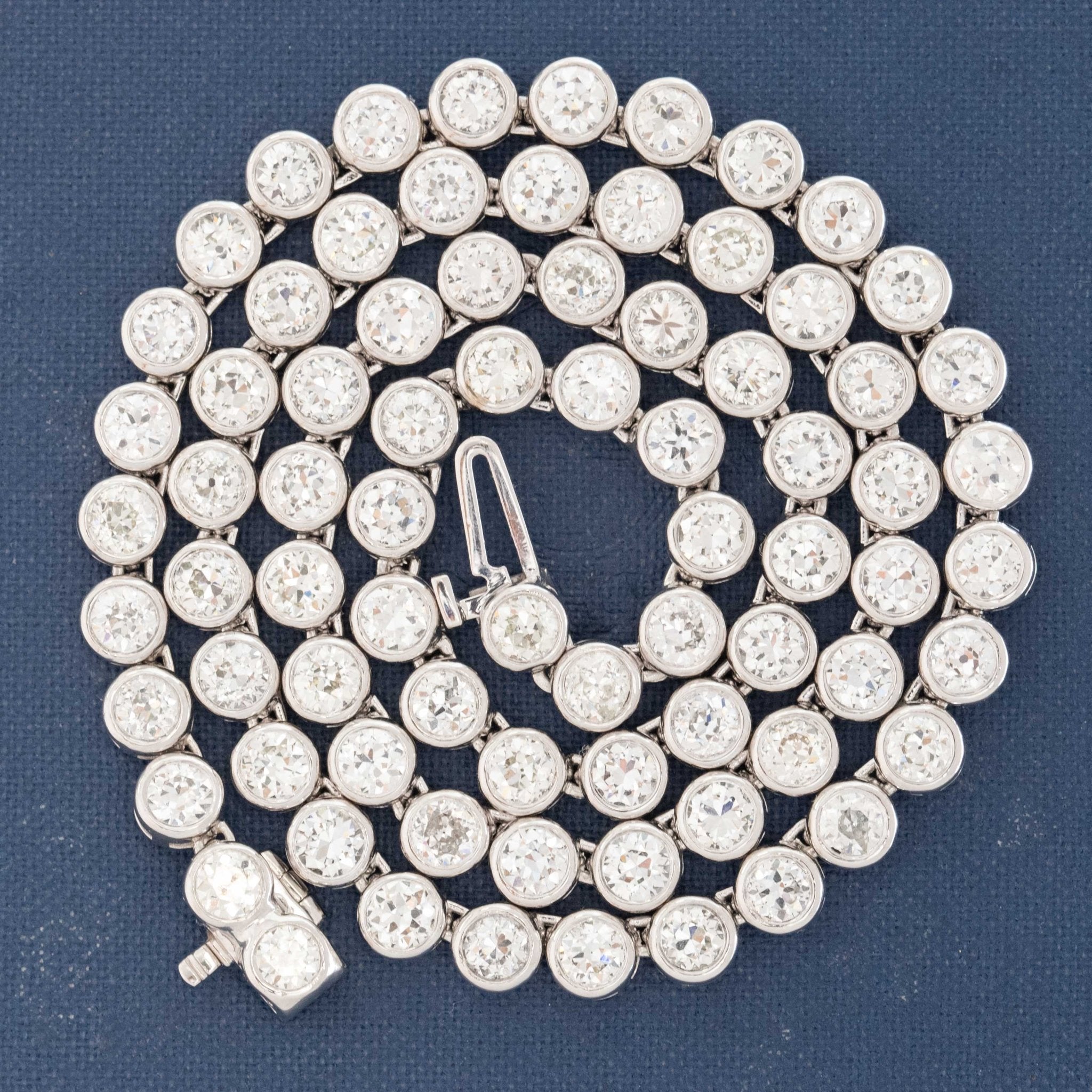 Detail of platinum bezels showcasing antique diamond faceting and fire