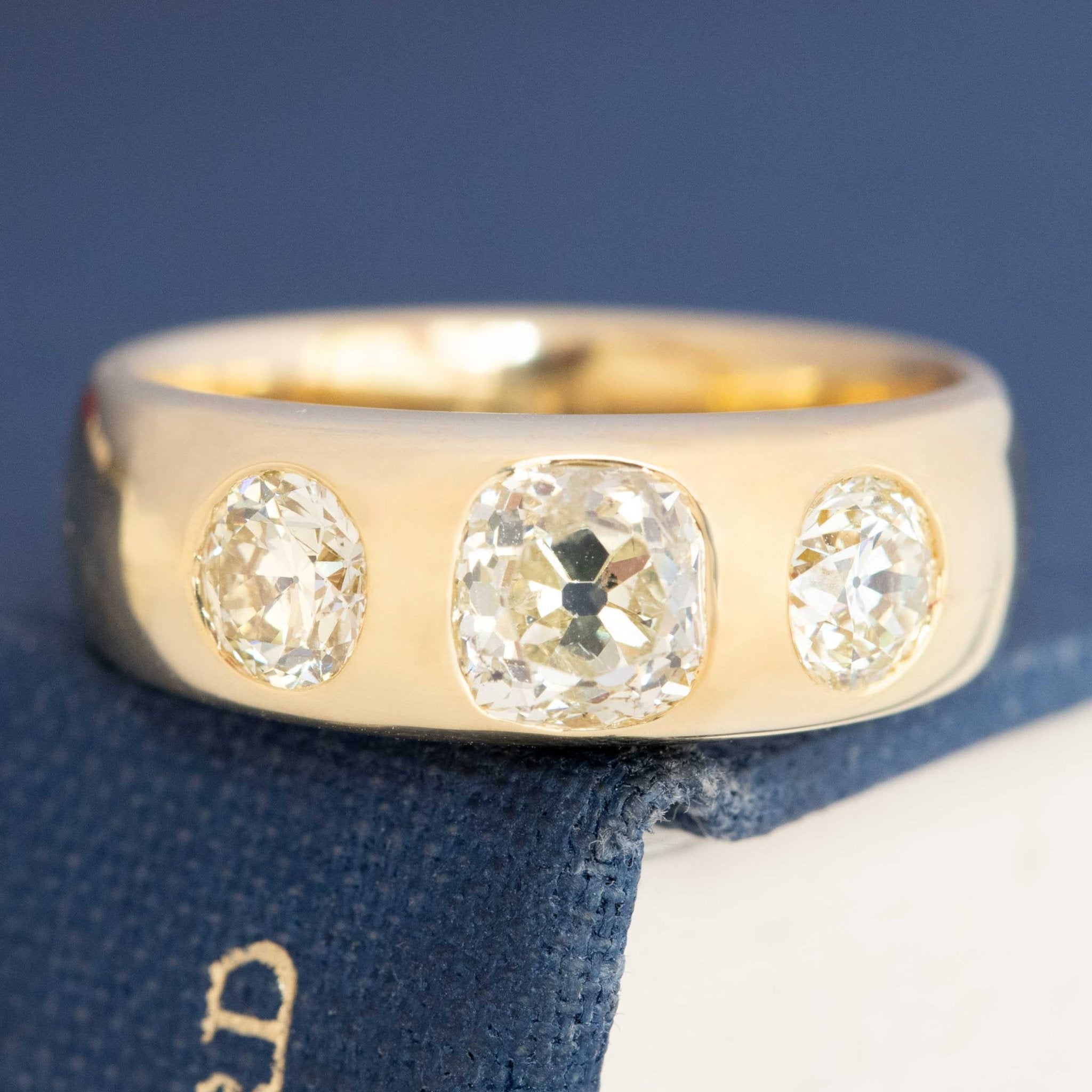 Close-up of vintage trilogy diamond ring, antique cuts