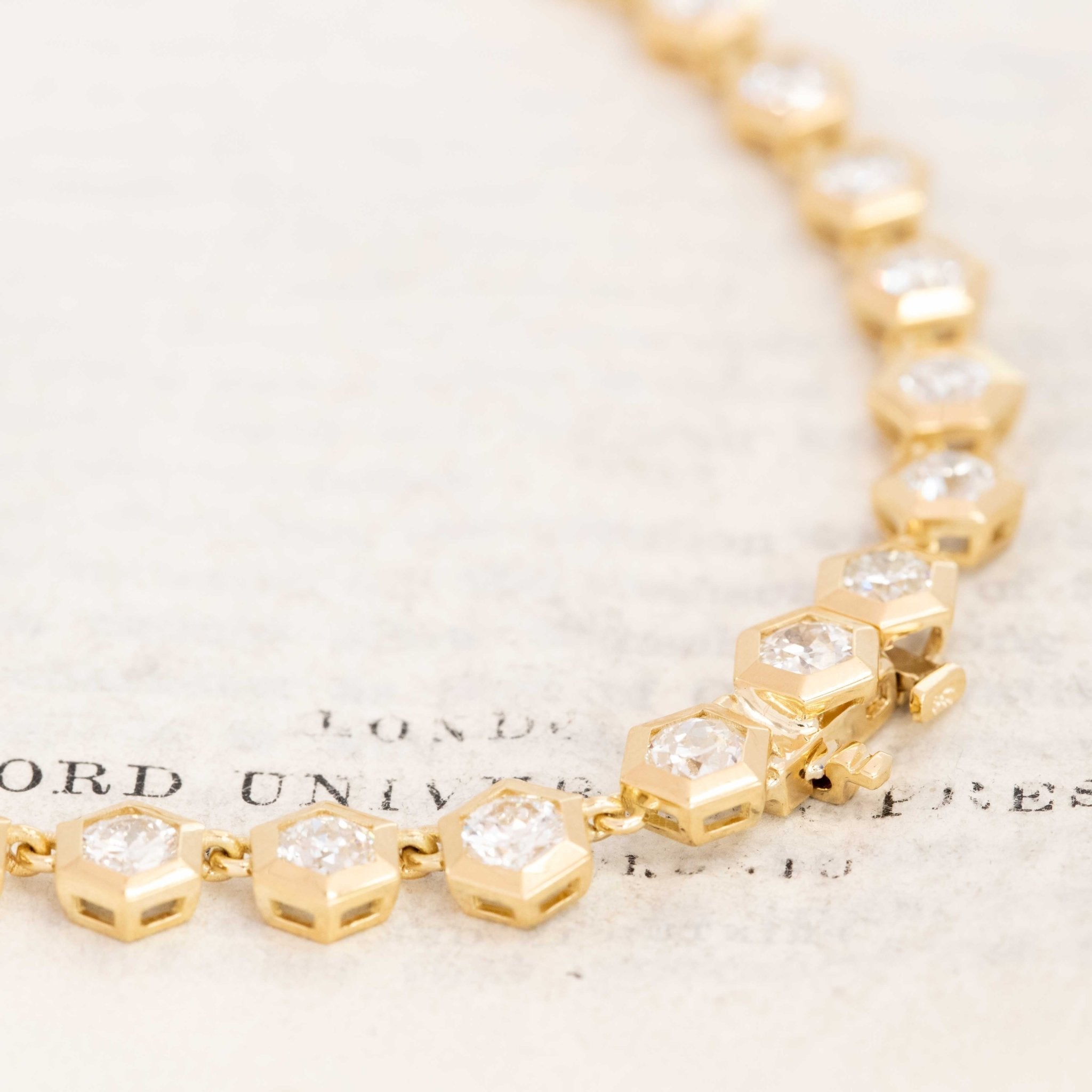 Vintage-style Old European cut diamond necklace. Detailed shot highlighting hexagonal bezel craftsmanship in yellow gold