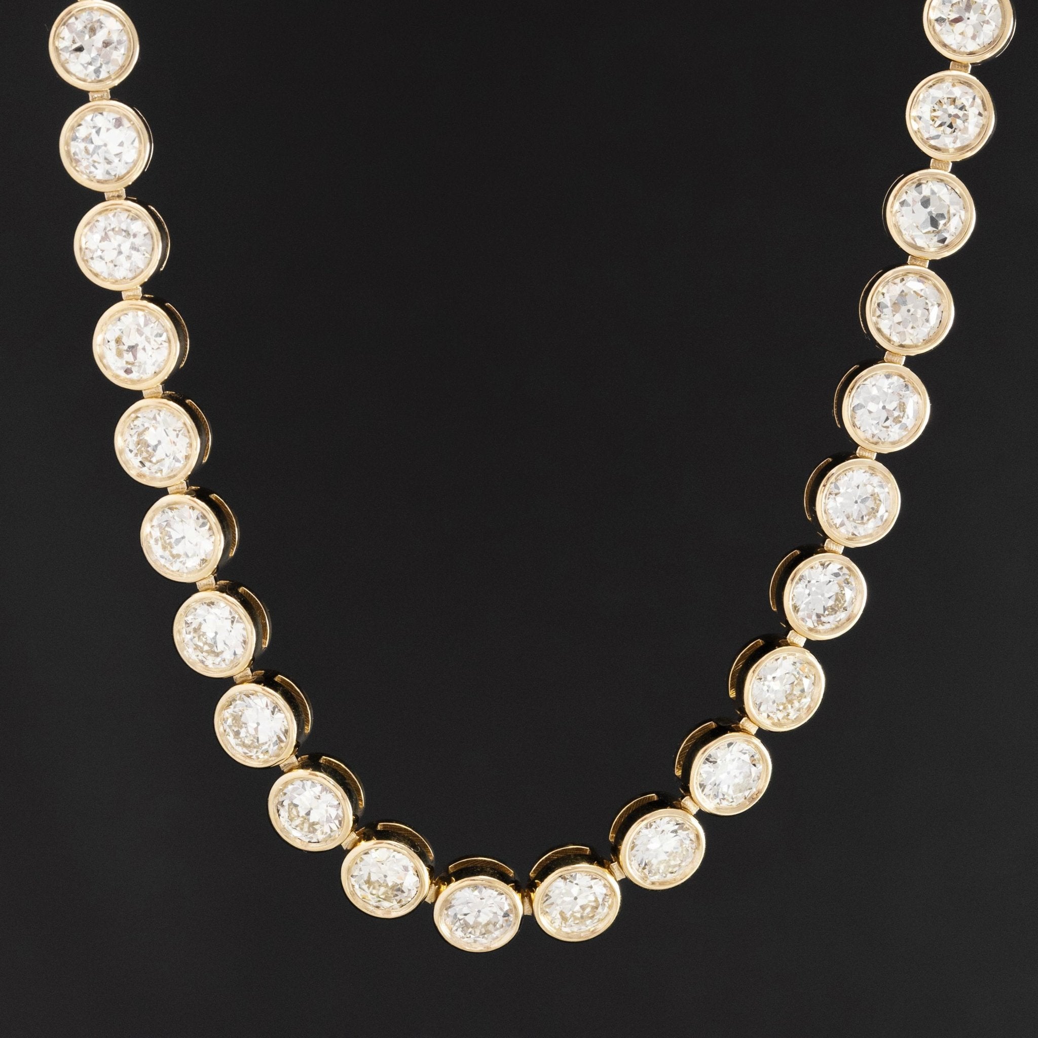 18.66ctw Antique diamond rivière necklace in yellow gold handcrafted in Los Angeles with vintage old-cut diamonds in yellow gold, forming a continuous river of light.