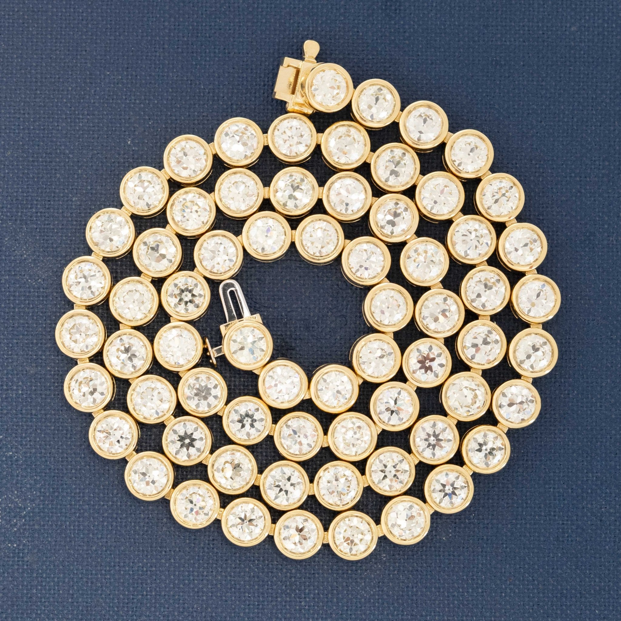 Close-up of 18.66ctw old-cut vintage diamonds set in a handcrafted yellow gold rivière necklace made in Los Angeles.