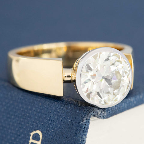 Antique style bezel diamond ring with warm gold band
