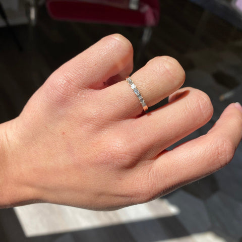 Elegant .18ctw Slim Baguette Cut Diamond 7-Stone Band, romantic design with Baguette Cut Diamonds, Earth-mined diamonds in yellow gold on ring finger.