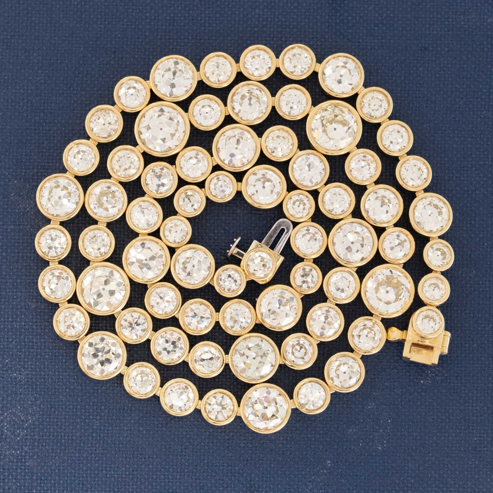 Riviere with bezel set old European cut diamonds in varying sizes in yellow gold.  The differing sizes give the piece a more contemporary feel yet so unique in that the diamonds are all vintage diamonds.
