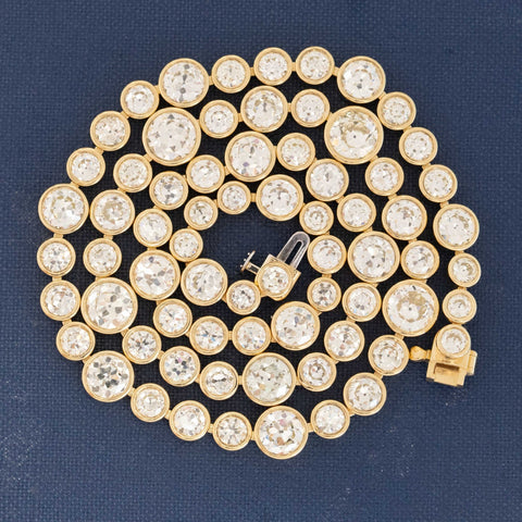 Riviere with bezel set old European cut diamonds in varying sizes in yellow gold.  The differing sizes give the piece a more contemporary feel yet so unique in that the diamonds are all vintage diamonds.