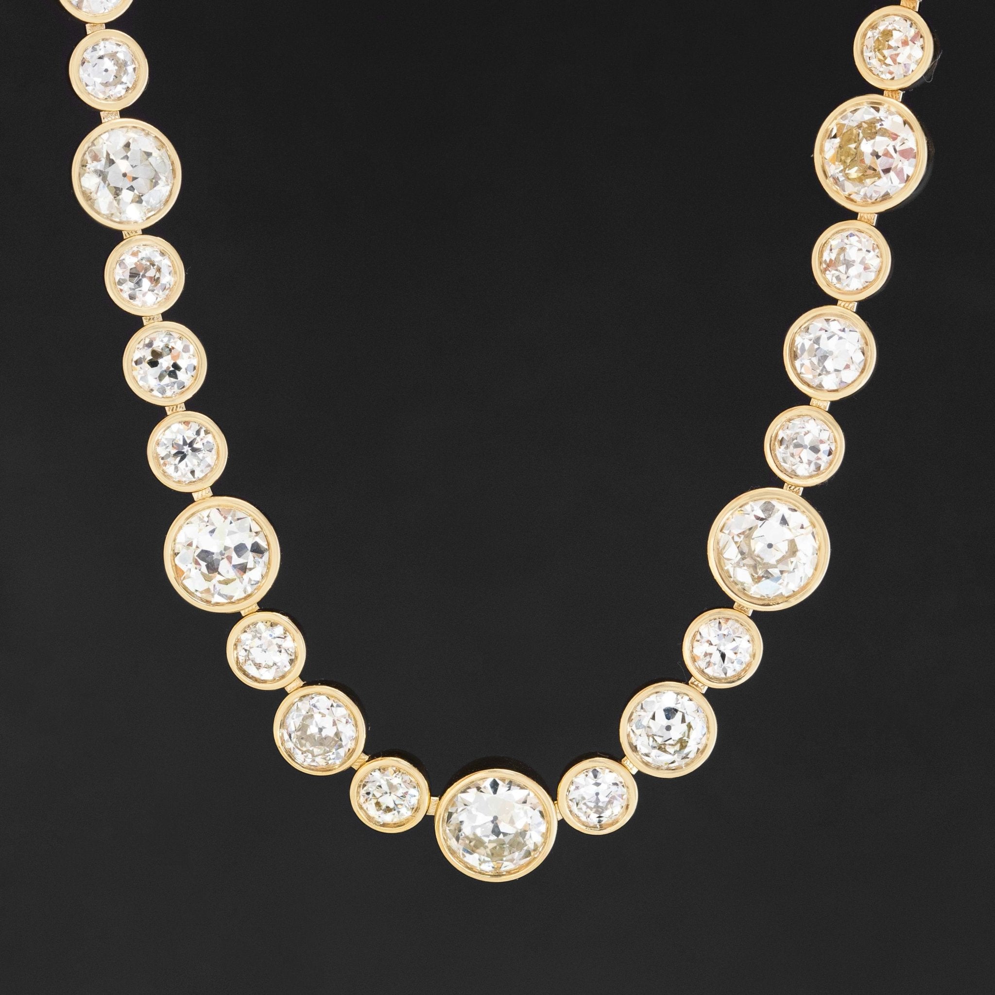 Riviere with bezel set old European cut diamonds in varying sizes in yellow gold.  The differing sizes give the piece a more contemporary feel yet so unique in that the diamonds are all vintage diamonds.